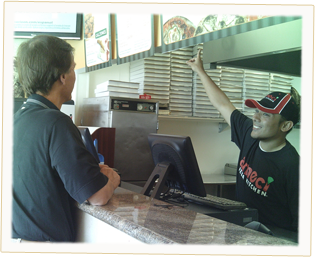 One of our top-selling Ameci's franchises, with one of our friendly employees helping a customer with an order.